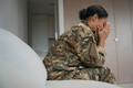 Tired african american female soldier sits alone in bright room - PhotoDune Item for Sale