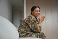 Smiling african american female soldier is sitting in a bright room - PhotoDune Item for Sale