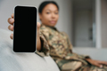 African american female soldier demonstrates the screen of the phone - PhotoDune Item for Sale