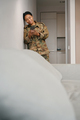 Pacified african american female soldier stands in the living room - PhotoDune Item for Sale