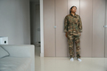 African american female soldier stands in a bright living room - PhotoDune Item for Sale