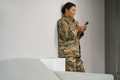 Joyful african american military woman is standing in living room - PhotoDune Item for Sale