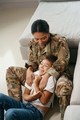 Mother soldier and son play cheerfully in the room - PhotoDune Item for Sale