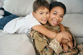 Mixed race boy tenderly hugs his mother, woman in military uniform - PhotoDune Item for Sale