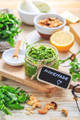 Homemade arugula pesto with ingredients on wooden background - PhotoDune Item for Sale
