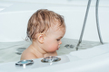 Happy baby child sitting in a bath. Bathing without tears - PhotoDune Item for Sale
