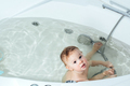 Kid taking bath, child bathing in bathtub, little baby playing with water. - PhotoDune Item for Sale