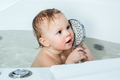 Happy baby child sitting in a bath. Bathing without tears. - PhotoDune Item for Sale