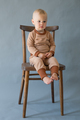 Portrait cute one year old baby girl, sitting on a wooden chair - PhotoDune Item for Sale