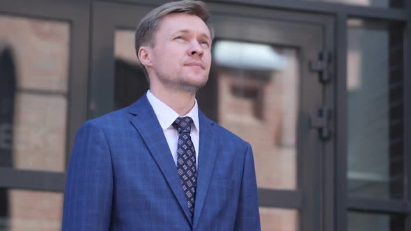 Serious Businessman Standing Outside Office