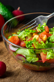 Fresh vegetable salad in a glass bowl on dark background. Vegan organic food, seasonal summer dish. - PhotoDune Item for Sale