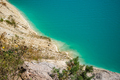 Unusual lake with turquoise water in the crater. Rocky stony shore chalk quarry in Belarus. - PhotoDune Item for Sale