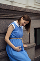 Pregnant woman touching her belly while sitting and resting - PhotoDune Item for Sale
