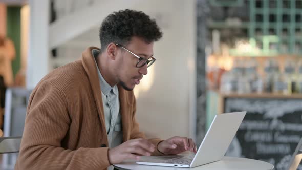 Successful African Man Celebrating Laptop Cafe