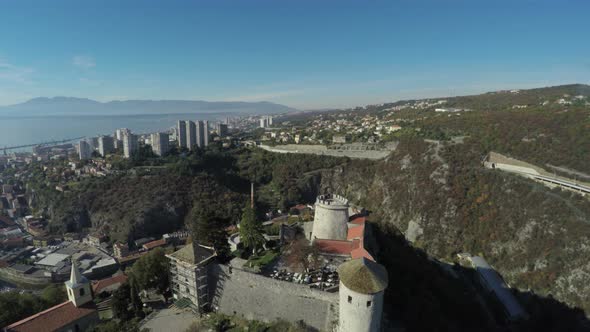 Aerial view of a castle near a city by the water