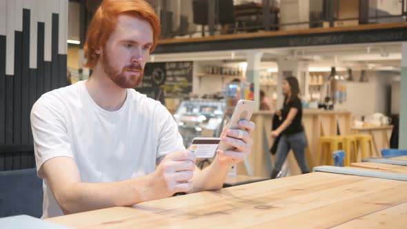 Redhead Man in Cafe Shopping Online on Smartphone, Payment