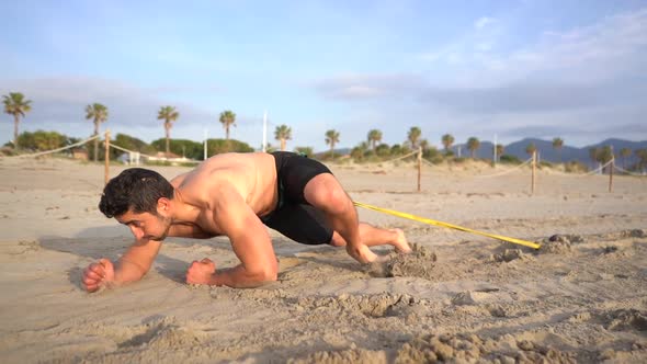 athlete practicing drag on elbows with resistance at sunrise