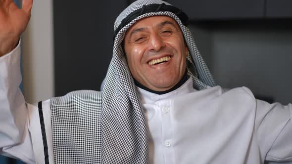 Front View Portrait of Cheerful Middle Eastern Handsome Man in Traditional Dishdasha and Chequered