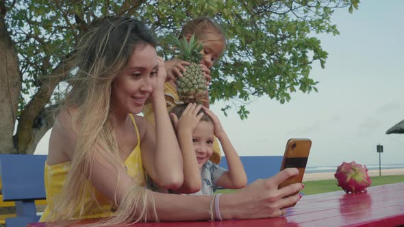 Woman Making Selfie with Her Kids on Beach