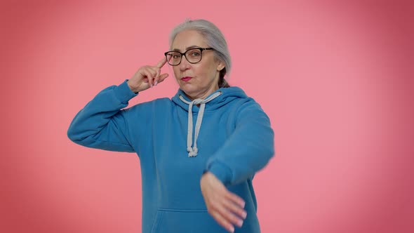 Senior Old Woman Pointing at Camera and Showing Stupid Gesture Blaming Some Idiot for Insane Plan