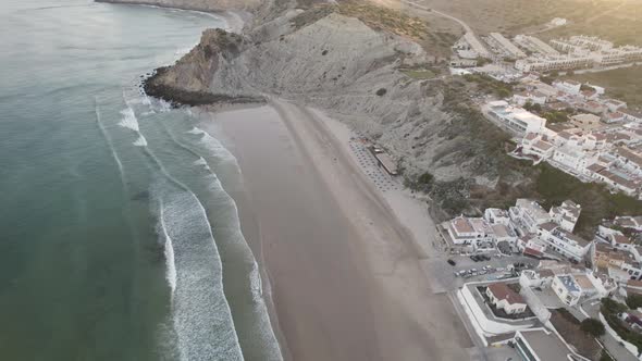 Burgau Beach, Algarve,Portugal.  Waves washing up on sand. Aerial wide shot