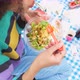 Close up vegan young woman eating salad outdoor - VideoHive Item for Sale