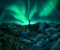 Northern lights and young woman on mountain peak at night. Auror - PhotoDune Item for Sale