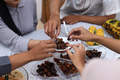 Group of people eating a healthy dates fruits. - PhotoDune Item for Sale