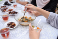 hand taking Indonesian food named Kolak or Kolek - PhotoDune Item for Sale
