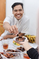 Muslim man eating a healthy food dates - PhotoDune Item for Sale