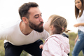 Close up photo of a father kissing his daughter outdoors - PhotoDune Item for Sale