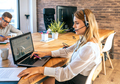 Young woman with headset in customer service of coworking - PhotoDune Item for Sale