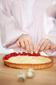 Woman decorating cake with berries and cream cheese. Close-up of female hands making tartlet - PhotoDune Item for Sale