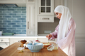 Young muslim woman in hijab preparing breakfast in kitchen at home. Arab woman Baking - PhotoDune Item for Sale
