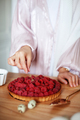 Close-up of woman's hands decorating raspberry tart, making delicious pie with fresh berries - PhotoDune Item for Sale