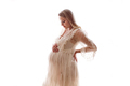 Beautiful pregnant woman long blonde hair in white dress stands sideways and touches her belly  - PhotoDune Item for Sale