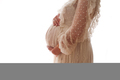 Close up pregnant woman in white lace dress stands side view and touches her belly - PhotoDune Item for Sale