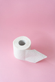 A roll of textured toilet paper with a pink background - PhotoDune Item for Sale