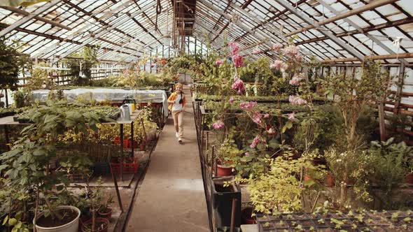 Joyous Little Girl Running through Greenhouse Farm