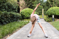 Cute little caucasian Girl with blonde hair Stretching outdoor on backyard Before Running - PhotoDune Item for Sale