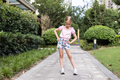Cute little caucasian Girl with blonde hair Stretching outdoor on backyard Before Running - PhotoDune Item for Sale