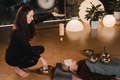 A young beautiful woman is doing a massage with singing bowls and a koshi bell to another girl - PhotoDune Item for Sale