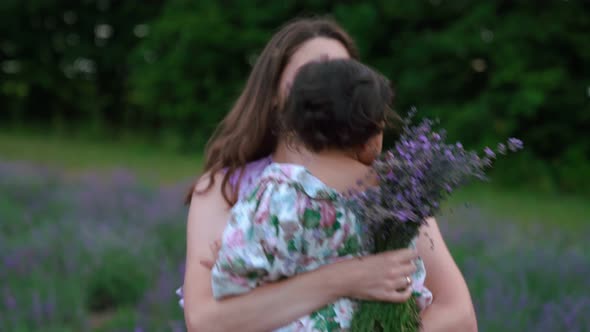 Mother Dancing with Child on Hands in Lavender Field