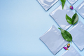 Blue plastic tea bag sachets or envelopes with dry rosebuds and green leaves. - PhotoDune Item for Sale