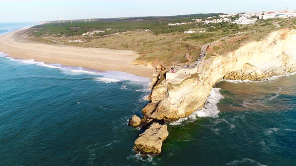 Aerial Top View of Lighthouse in Nazare with Big Waves