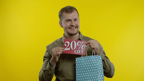 Happy Man Showing 20 Percent Off Inscription From Shopping Bag, Smiling, Rejoicing Discounts