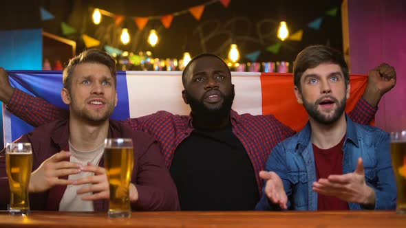 Anxious Multiethnic French Fans Unhappy With Team Losing Game, Sitting in Pub