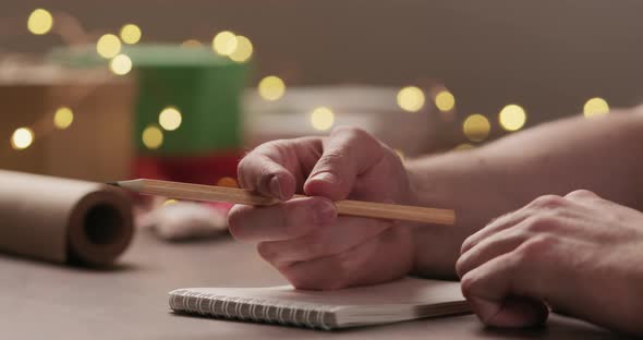 Man Reading Shopping List Holidays Notepad Under Warm Light Evening