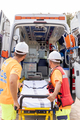 Vertical photo of lifeguard team working with ambulance - PhotoDune Item for Sale