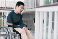 Concept of Family Caregiving in everyday life for happy teenage boy with disability on wheelchair. - PhotoDune Item for Sale